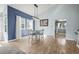 Bright dining room with modern light fixture, hardwood floors, and large windows at 8815 W Quarto Cir, Littleton, CO 80128