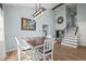 Dining room with modern lighting, stairs, and a view into the living room at 8815 W Quarto Cir, Littleton, CO 80128