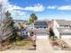 Beautiful blue two-story home featuring solar panels, a manicured lawn and an attached two car garage at 8815 W Quarto Cir, Littleton, CO 80128