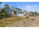 Charming home exterior with a well-manicured front lawn and attached two-car garage at 8815 W Quarto Cir, Littleton, CO 80128