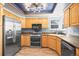 Well-equipped kitchen features stainless steel appliances and wooden cabinetry at 8815 W Quarto Cir, Littleton, CO 80128