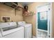 Laundry room features washer, dryer, and shelving for storage at 8815 W Quarto Cir, Littleton, CO 80128