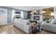Comfortable living room boasts fireplace, mantel with decor, large window, and a comfy couch at 8815 W Quarto Cir, Littleton, CO 80128