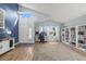 Spacious living room boasts vaulted ceilings, bright windows, and stylish built-in shelving at 8815 W Quarto Cir, Littleton, CO 80128