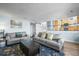 Cozy living room features stylish sofas, a coffee table, and access to the kitchen at 8815 W Quarto Cir, Littleton, CO 80128