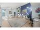 Spacious living room featuring high ceilings, hardwood floors and staircase access at 8815 W Quarto Cir, Littleton, CO 80128
