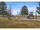 Community playground featuring mature trees and seating, creating a welcoming recreational area at 8815 W Quarto Cir, Littleton, CO 80128