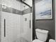 This bathroom features a modern glass-enclosed shower with decorative tile and contemporary fixtures at 8815 W Quarto Cir, Littleton, CO 80128