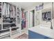 A walk-in closet showcases custom shelving, hanging rods, and a modern vanity with a white marble countertop at 8815 W Quarto Cir, Littleton, CO 80128