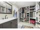 A spacious walk-in closet features custom shelving, a vanity area, and a stylish gray vanity with a marble countertop at 8815 W Quarto Cir, Littleton, CO 80128