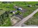Aerial view of the property showing the house, garages, parking, driveway and surrounding land at 1166 Belgian Trl, Elizabeth, CO 80107