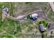 This property includes an aerial view of the home, landscaping, and other buildings on the property with dirt roads throughout at 1166 Belgian Trl, Elizabeth, CO 80107