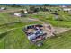 An aerial view of land with multiple outbuildings and a main house nestled within a scenic landscape at 1166 Belgian Trl, Elizabeth, CO 80107