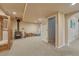 Finished basement featuring a wood-burning stove, wood storage, and neutral carpet at 1166 Belgian Trl, Elizabeth, CO 80107