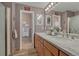 Bathroom features a double vanity with marble countertop and framed mirrors at 1166 Belgian Trl, Elizabeth, CO 80107