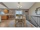 Bright dining area with a wooden table set, seamlessly connected to the kitchen and stairway at 1166 Belgian Trl, Elizabeth, CO 80107