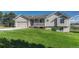 Charming home with well-manicured front lawn and covered porch, enhancing curb appeal at 1166 Belgian Trl, Elizabeth, CO 80107