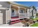 Charming front porch with red accents and welcoming curb appeal on a sunny day at 1166 Belgian Trl, Elizabeth, CO 80107