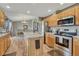 Open kitchen featuring stainless steel appliances, a center island, and stylish cabinetry at 1166 Belgian Trl, Elizabeth, CO 80107