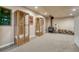 Basement Living Room with display cabinets, wood stove, and a supply of firewood at 1166 Belgian Trl, Elizabeth, CO 80107