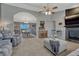 Inviting living room featuring a fireplace, comfortable seating and view into the dining area at 1166 Belgian Trl, Elizabeth, CO 80107