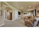 Basement living room with comfortable seating, media center, and an arched doorway at 1166 Belgian Trl, Elizabeth, CO 80107