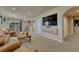 Cozy living room featuring leather furniture, a media center, and sliding glass doors to the exterior at 1166 Belgian Trl, Elizabeth, CO 80107