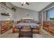 Comfortable main bedroom featuring a decorative ceiling fan, wood furnishings, and plush carpeting at 1166 Belgian Trl, Elizabeth, CO 80107