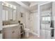 Well-maintained bathroom with a vanity, toilet, walk-in shower, and mirrored closet at 655 S Alton Way # 5C, Denver, CO 80247