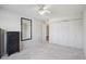 Large bedroom featuring carpet, ceiling fan, mirror, and closet with folding doors at 655 S Alton Way # 5C, Denver, CO 80247