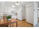Bright eat-in kitchen features white appliances and wood floors at 655 S Alton Way # 5C, Denver, CO 80247