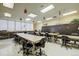 Spacious work room with tables, black office chairs, and storage lockers at 655 S Alton Way # 5C, Denver, CO 80247