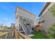 Backyard featuring deck access, lush lawn, and modern home exterior at 10200 Xanadu St, Commerce City, CO 80022