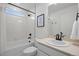 Bright bathroom with white tiled shower/tub combination and modern fixtures at 10200 Xanadu St, Commerce City, CO 80022
