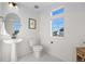 Bright half bathroom features a pedestal sink, decorative tile floor and window with neighborhood view at 10200 Xanadu St, Commerce City, CO 80022