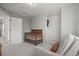 Bedroom featuring a wood crib, chair, and gray carpet at 10200 Xanadu St, Commerce City, CO 80022