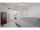 Comfortable bedroom features a sliding barn door that leads into a bathroom with dual vanity at 10200 Xanadu St, Commerce City, CO 80022