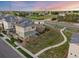 Lovely two-story home with fenced yard, landscaping, and a walkway at sunset at 10200 Xanadu St, Commerce City, CO 80022
