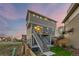 The exterior showcases a modern design with a staircase leading to a private deck, enhancing outdoor living at 10200 Xanadu St, Commerce City, CO 80022