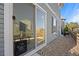 A back exterior view features a sliding glass door with a pet door and a rock garden at 10200 Xanadu St, Commerce City, CO 80022