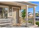 A welcoming front porch features stone accents, a bench, and a stylish front door at 10200 Xanadu St, Commerce City, CO 80022