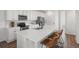 Bright kitchen with white cabinetry, stainless steel appliances, and an expansive center island at 10200 Xanadu St, Commerce City, CO 80022