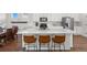 Bright kitchen with white cabinetry, stainless steel appliances, and an expansive center island at 10200 Xanadu St, Commerce City, CO 80022