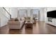 Bright living room with hardwood floors, modern furniture, and large windows at 10200 Xanadu St, Commerce City, CO 80022