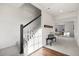 Carpeted staircase leads to a living area with bench and hardwood floors at 10200 Xanadu St, Commerce City, CO 80022