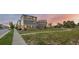 A wide street view showcases a multi-story home with a modern exterior, complimented by a green space at 10200 Xanadu St, Commerce City, CO 80022