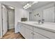 Bright bathroom featuring a single vanity, large mirror, and a door leading to the shower at 5878 Berry Ridge Way, Castle Rock, CO 80104