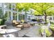 Serene backyard with a stone fire pit, comfortable seating, and mature trees for a peaceful retreat at 4483 W Cottonwood Pl, Littleton, CO 80123