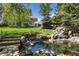 Extensive backyard with waterfall feature, pergola-covered dining, and lawn at 4483 W Cottonwood Pl, Littleton, CO 80123