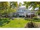 Beautifully landscaped backyard with patio, outdoor kitchen, and mature trees at 4483 W Cottonwood Pl, Littleton, CO 80123